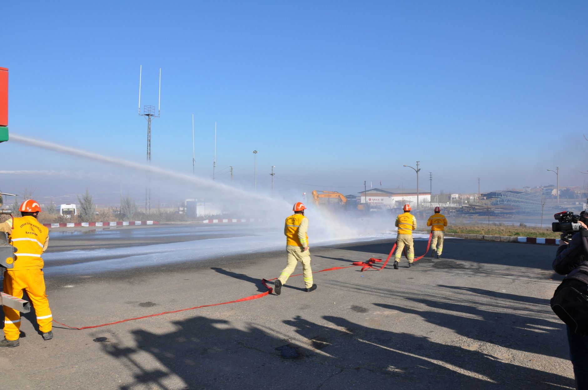 batman firefighters extinguishing fire on street