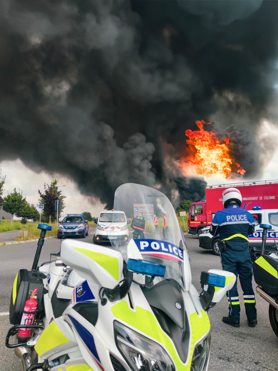 police standing on road near fire